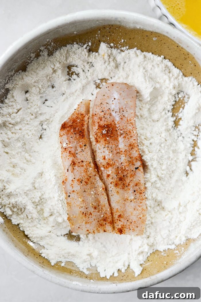 Golden Crispy Fish Sandwiches 10 Dredging fish in flour