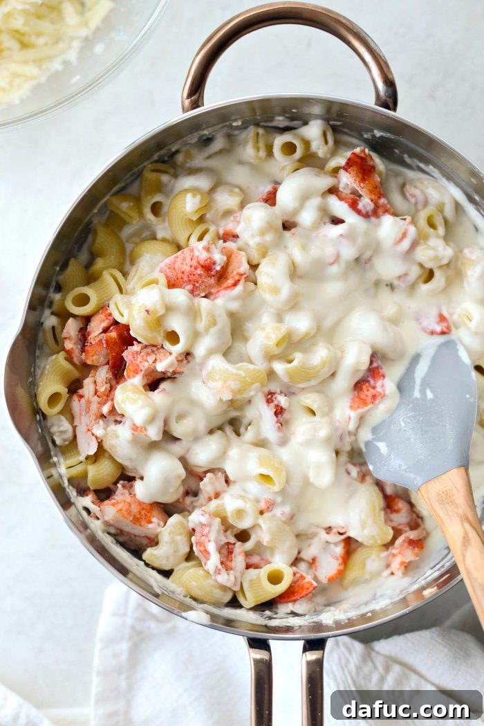 Opulent Lobster Mac and Cheese 16 Adding drained pasta to the creamy cheese sauce in a large bowl or saucepan.
