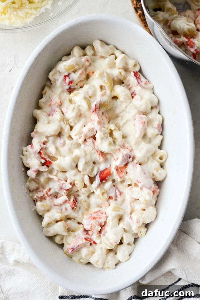 Opulent Lobster Mac and Cheese 18 Stirring cooked pasta and lobster into the cheese sauce to fully combine them.
