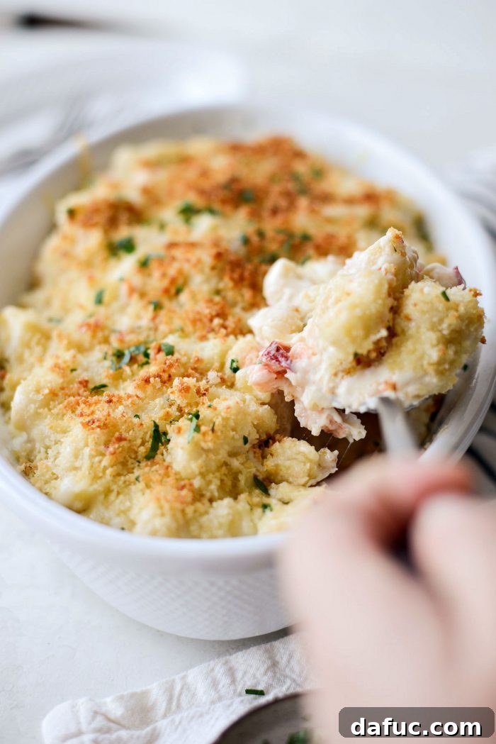 Opulent Lobster Mac and Cheese 24 A generous serving of Lobster Mac and Cheese, showcasing the creamy sauce, lobster, and crispy topping.