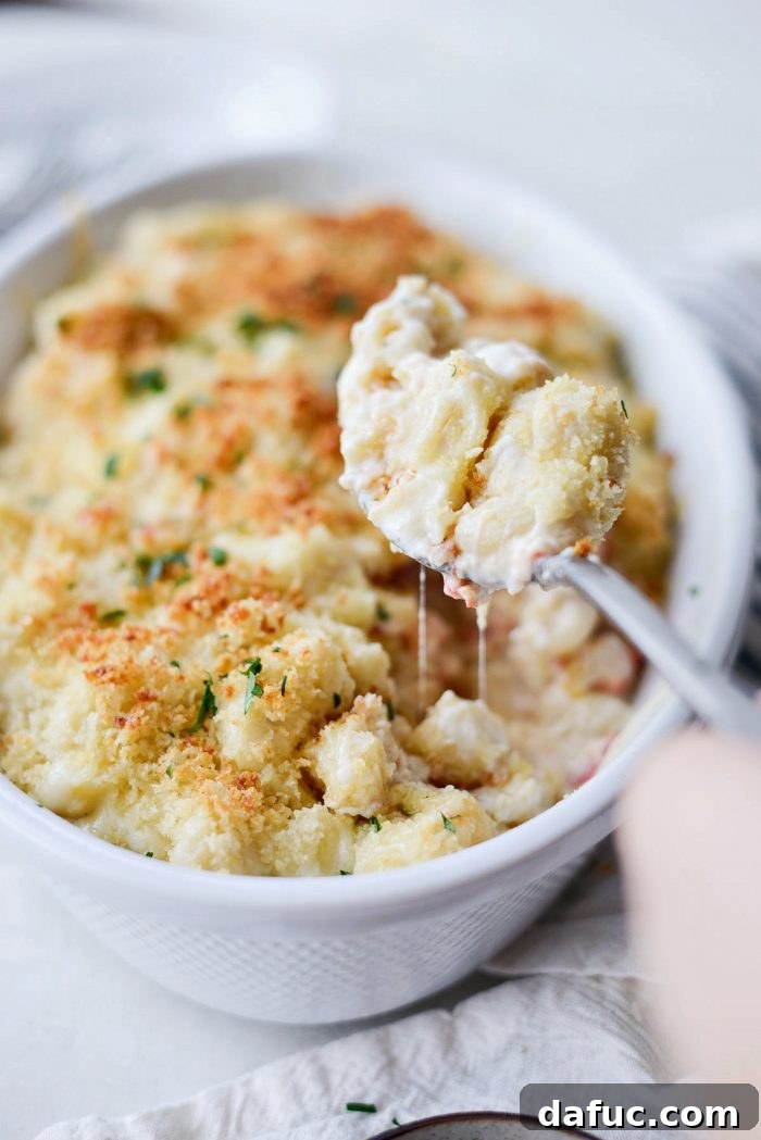 Opulent Lobster Mac and Cheese 25 Finished Lobster Mac and Cheese served in a baking dish, garnished with fresh parsley.