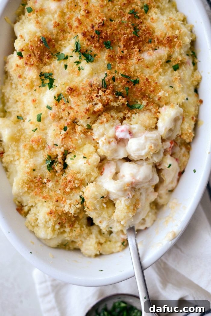 Opulent Lobster Mac and Cheese 26 A top-down view of a serving of Lobster Mac and Cheese in a bowl, ready to be enjoyed.