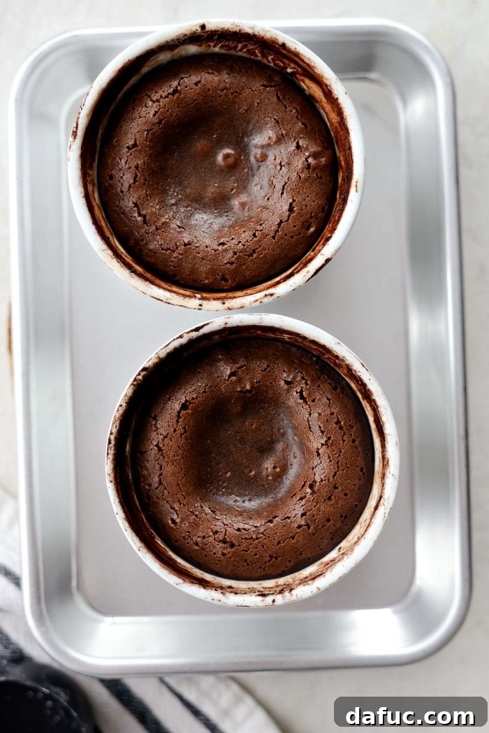 Molten chocolate lava cakes cooling in their ramekins after baking, resting before unmolding
