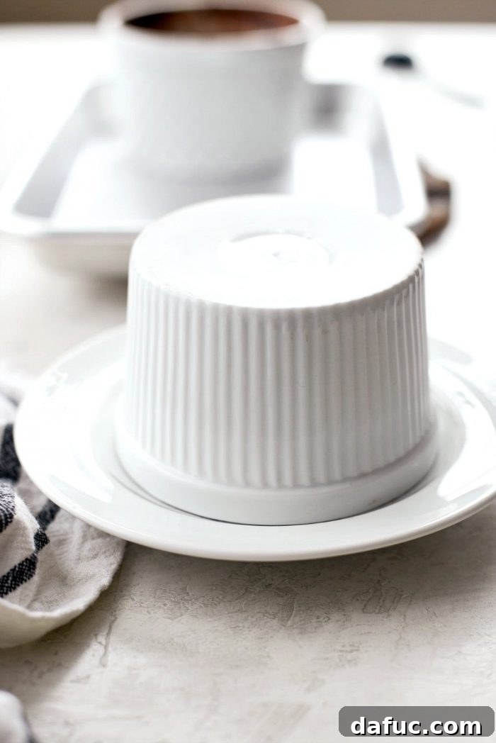 Carefully flipping a molten chocolate lava cake from its ramekin onto a dessert plate for serving