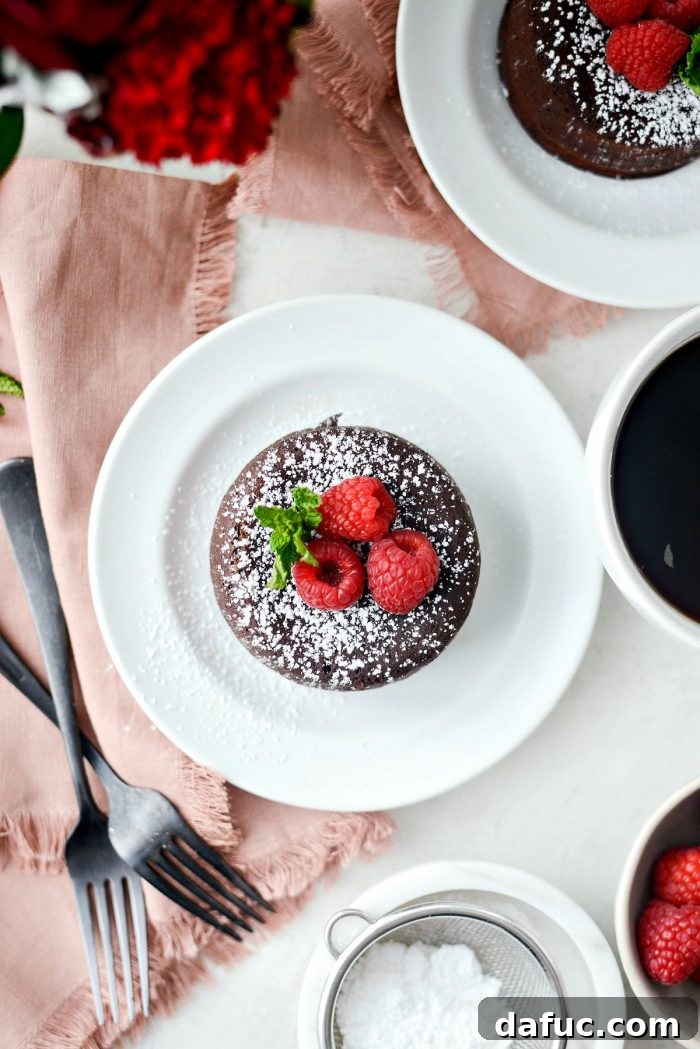 Molten chocolate lava cake beautifully dusted with powdered sugar and garnished with fresh berries