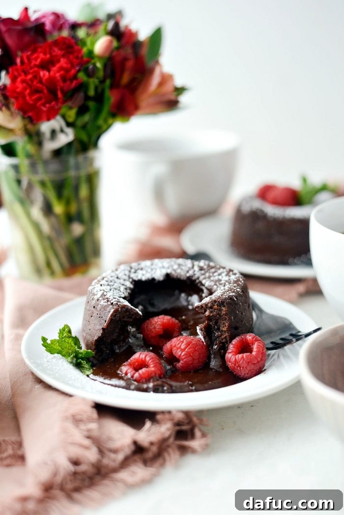 A molten chocolate lava cake being gently cut, revealing its irresistible gooey, warm center