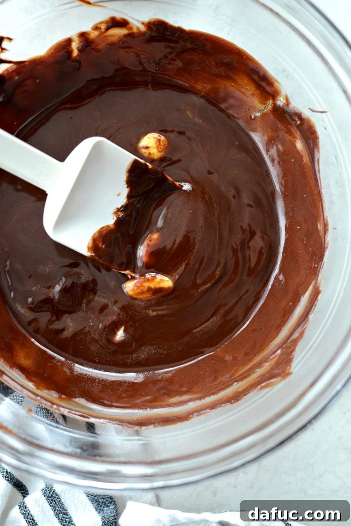 Chocolate, butter, and espresso powder melting gently over a double boiler for a rich lava cake base