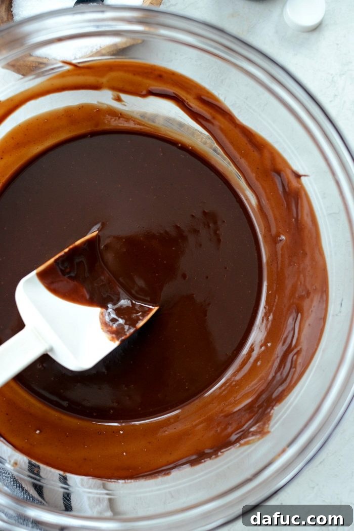 Adding vanilla extract and a pinch of kosher salt to the warm, melted chocolate mixture