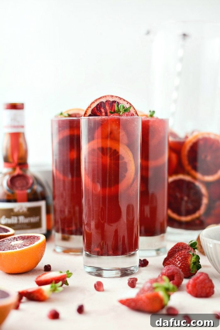 Champagne Sangria with fresh strawberries, pomegranate arils, and blood orange slices, perfect for Valentine's Day or Galentine's Day celebrations.