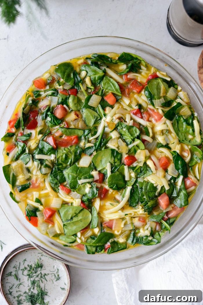 Egg and vegetable mixture stirred to combine all ingredients.