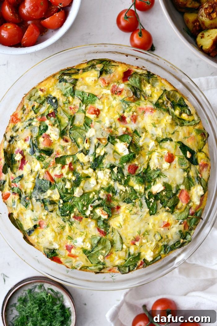 Baked Tomato Spinach and Feta Crustless Quiche cooling in the pie dish.