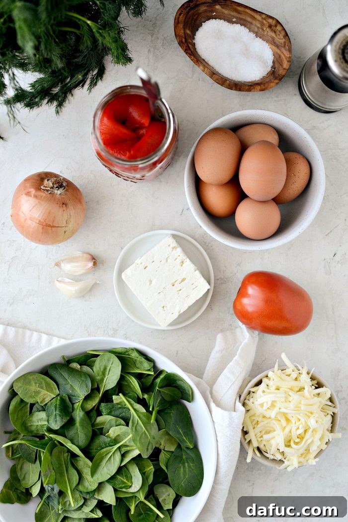 Fresh ingredients for Tomato Spinach and Feta Crustless Quiche before cooking.