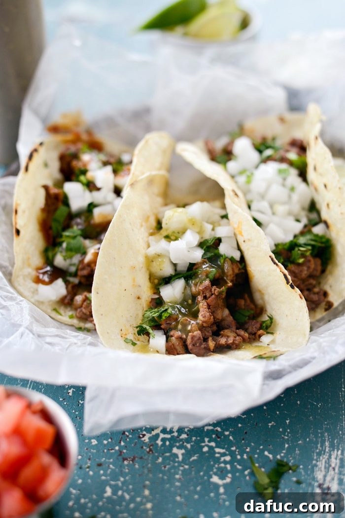 More finished Easy Beef Street Tacos presented beautifully, showing the vibrant colors of the toppings. SimplyScratch.com recipe.