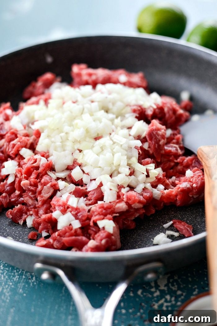Finely mincing skirt steak for Beef Street Tacos, showing the importance of a sharp knife for preparation. SimplyScratch.com recipe.