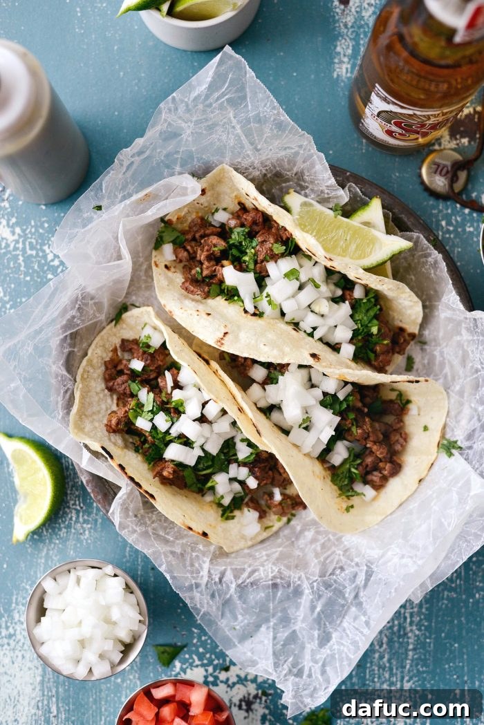 Toasting corn tortillas in a dry skillet for Beef Street Tacos, a key step for flexible, warm tortillas. SimplyScratch.com recipe.