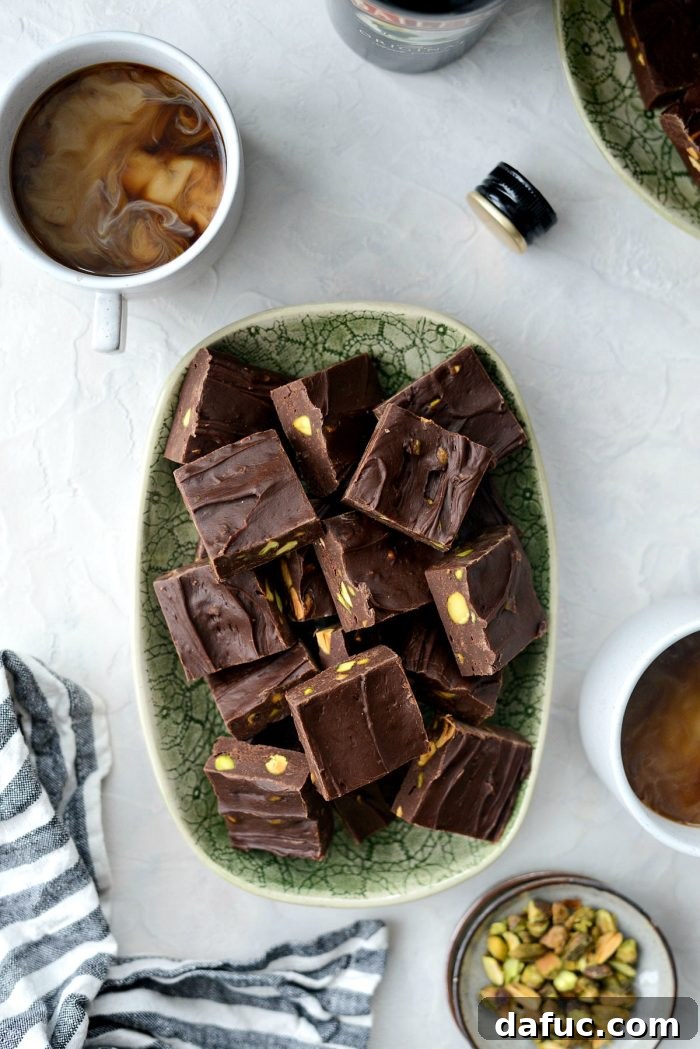 Perfectly cut squares of Baileys Chocolate Pistachio Fudge, garnished with extra pistachios.