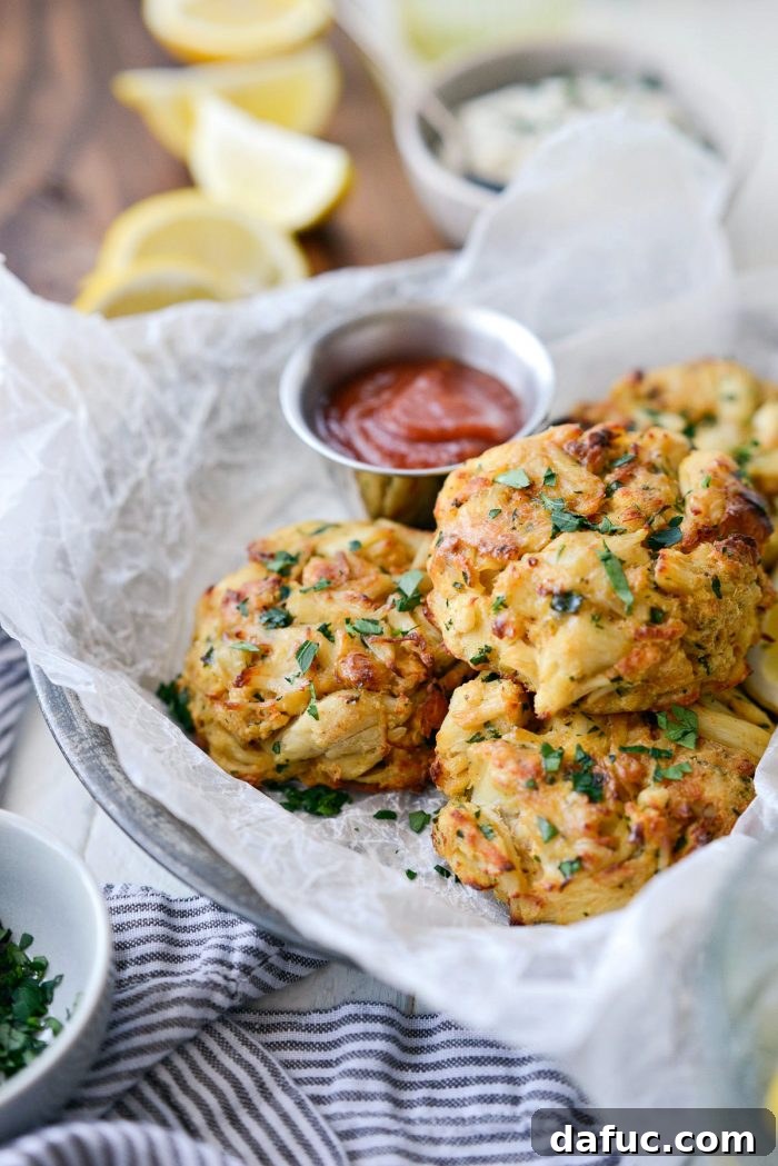 Golden Baked Maryland Crab Delights 18 A close-up shot of a baked Maryland crab cake, showing its crispy exterior and flaky interior, with tartar sauce.