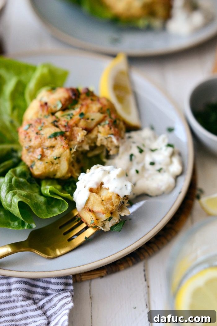 Golden Baked Maryland Crab Delights 21 A final close-up of a single crispy baked Maryland crab cake, glistening and ready to be enjoyed.