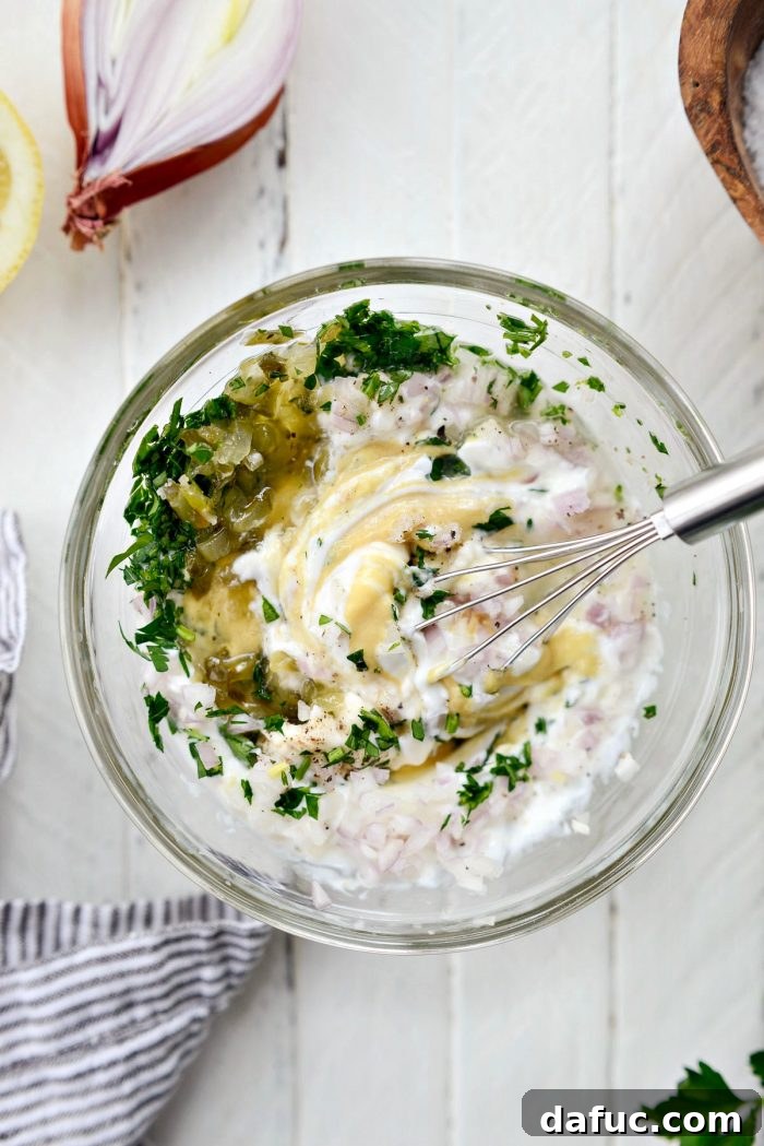 Golden Baked Maryland Crab Delights 5 Ingredients for tartar sauce being whisked together in a bowl.