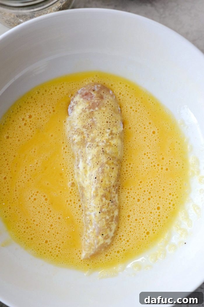 Dredging chicken tenders in seasoned flour
