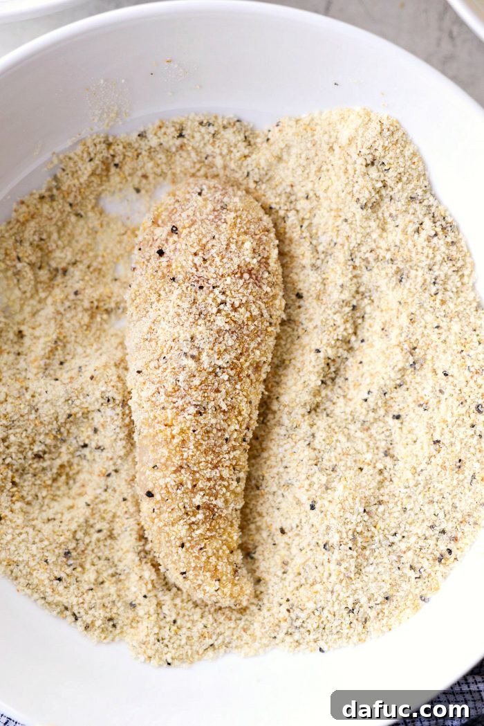 Dipping floured chicken tenders into beaten egg