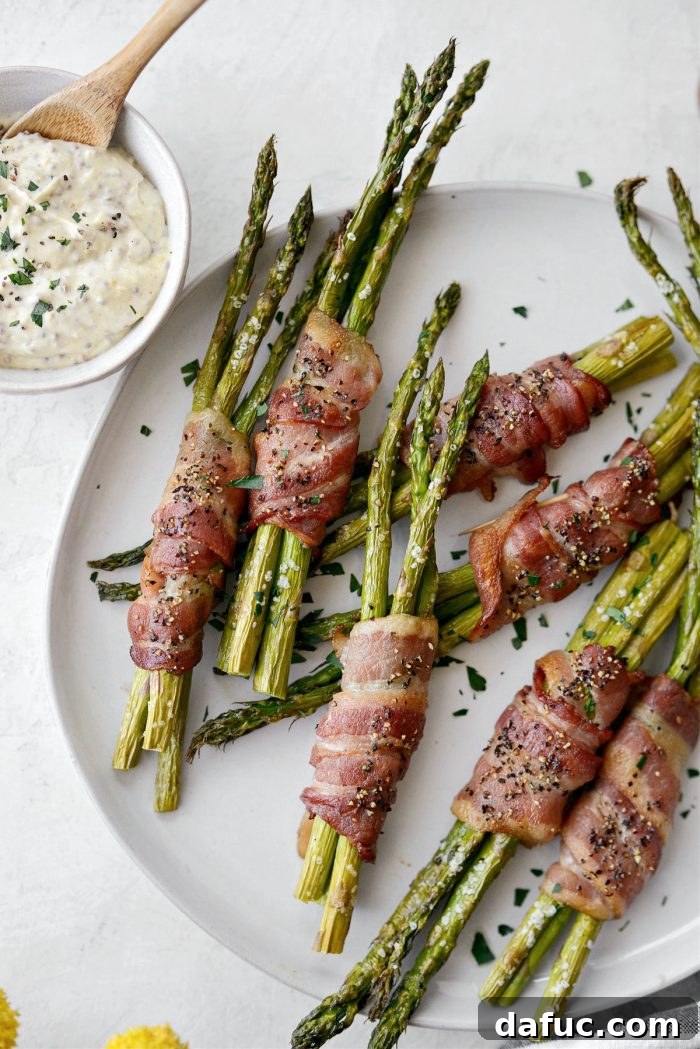 Crispy Bacon Asparagus Treats 2 Perfectly roasted Bacon Wrapped Asparagus Bundles served on a platter