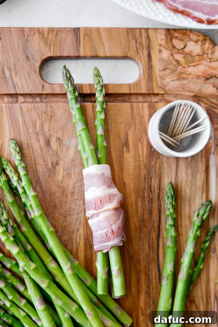 Crispy Bacon Asparagus Treats 7 Wrapping asparagus with a slice of bacon