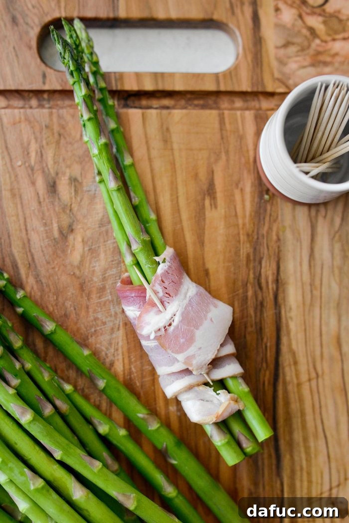 Crispy Bacon Asparagus Treats 8 Securing bacon wrapped asparagus with a toothpick