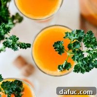 Carrot Orange Mimosa, a vibrant and refreshing spring cocktail perfect for brunch, made with carrot juice, orange juice, Grand Marnier, and Prosecco.