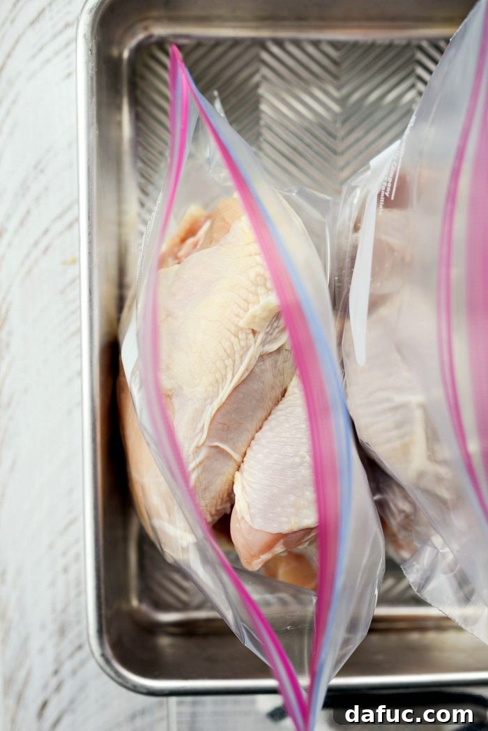 Close-up of assorted bone-in, skin-on chicken pieces ready for marination.