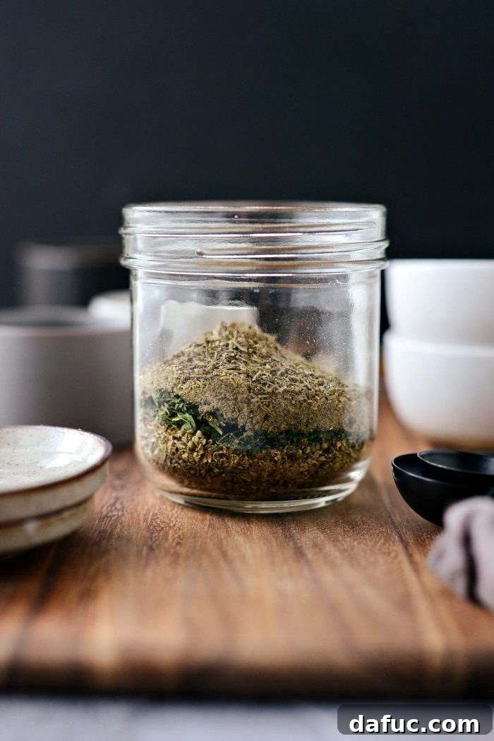 Assorted jars of dried herbs on a counter, ready to be combined for a homemade Italian seasoning blend, emphasizing fresh ingredients.
