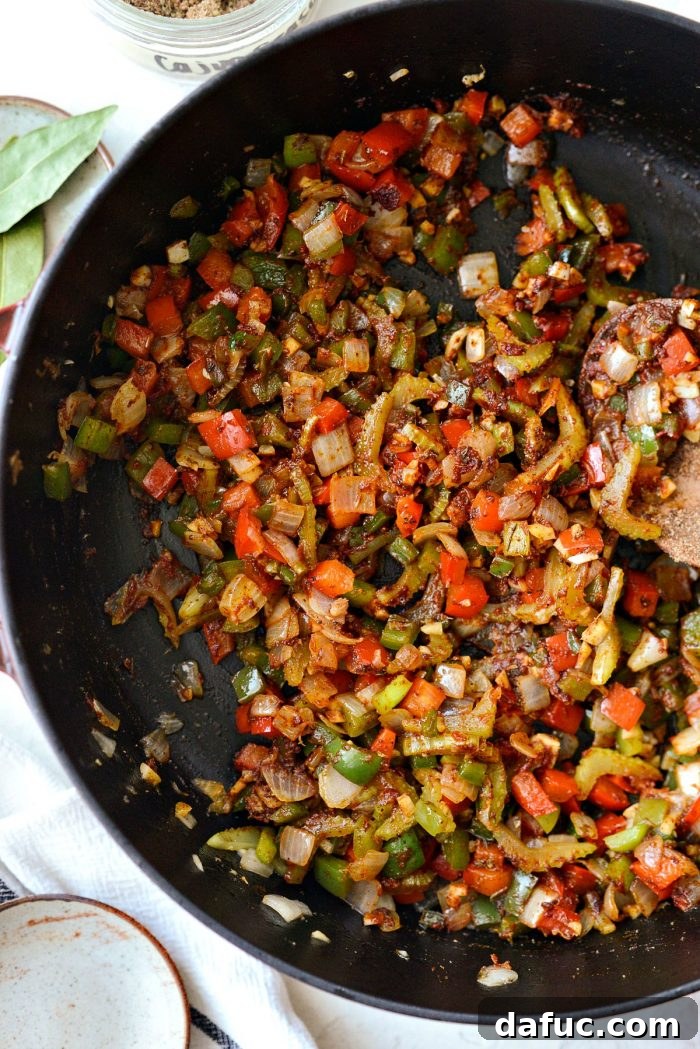 Effortless One-Pot Jambalaya 13 The spices and tomato paste stirred into the vegetables, creating a rich aromatic base for the jambalaya.