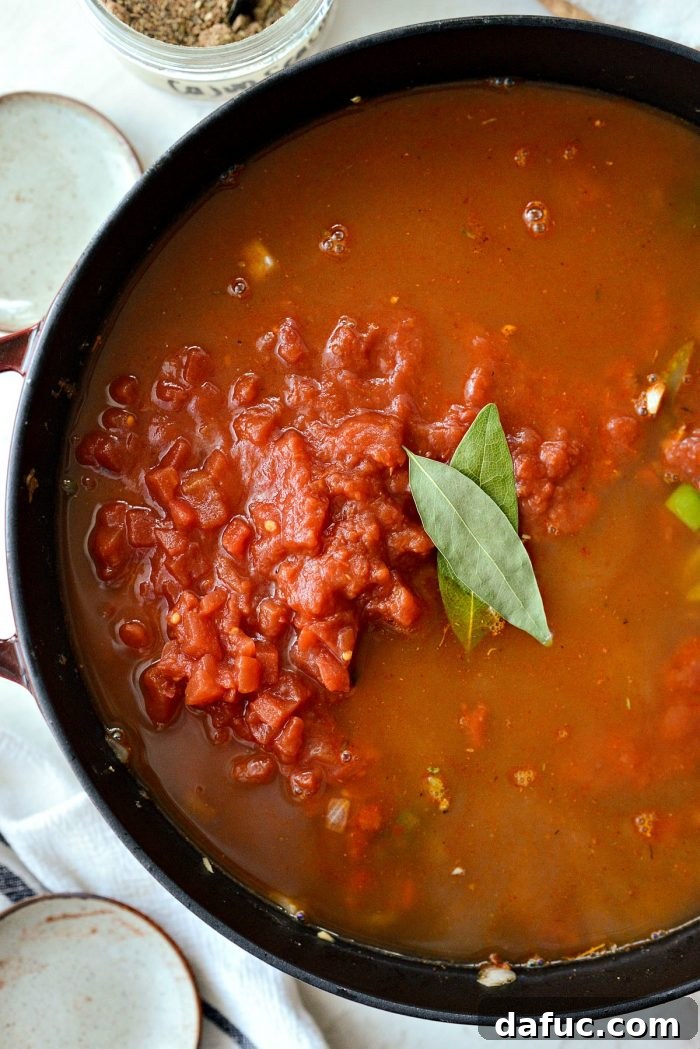 Effortless One-Pot Jambalaya 15 Bay leaves added to the tomato and stock mixture in the skillet, enhancing the aromatic depth of the jambalaya.