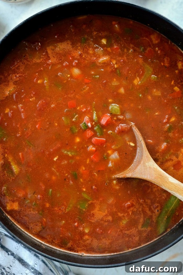 Effortless One-Pot Jambalaya 16 The bay leaves submerged in the rich, red jambalaya broth, ready for simmering.