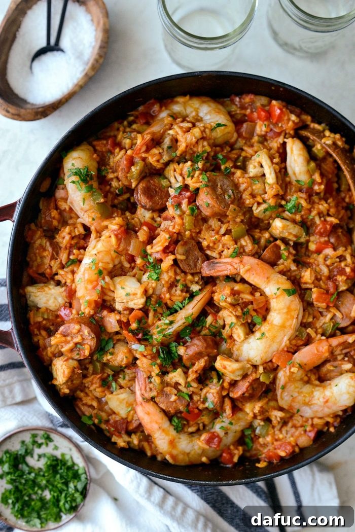 Effortless One Pot Jambalaya 23 Scoop of gorgeous, spicy One Pot Jambalaya ready to be served | SimplyScratch.com #skillet #shrimp #andouille #rice #creole #chicken #homemade