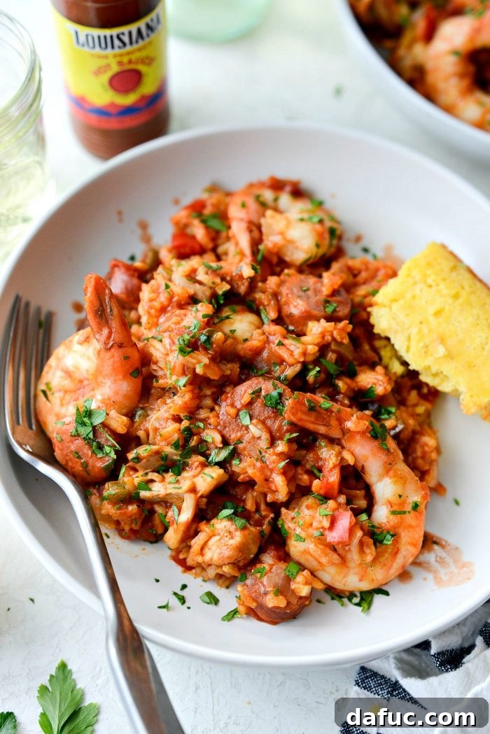 Effortless One Pot Jambalaya 25 Generous serving of One Pot Jambalaya, ready to eat with a spoon | SimplyScratch.com #skillet #shrimp #andouille #rice #creole #chicken #homemade