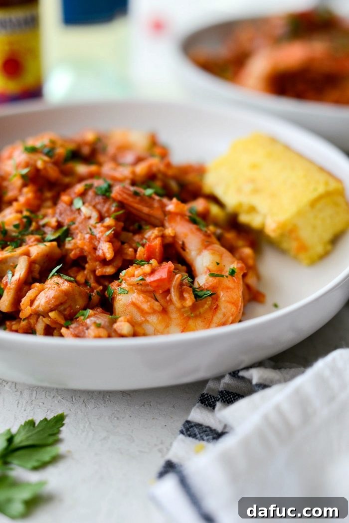 Effortless One Pot Jambalaya 29 Overhead view of a prepared One Pot Jambalaya in a skillet, ready to serve | SimplyScratch.com #skillet #shrimp #andouille #rice #creole #chicken #homemade
