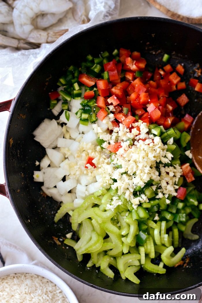 Effortless One-Pot Jambalaya 9 The diced 'holy trinity' vegetables (onion, celery, bell pepper) and jalapeno added to the skillet, ready to be sautéed to form the flavor base.