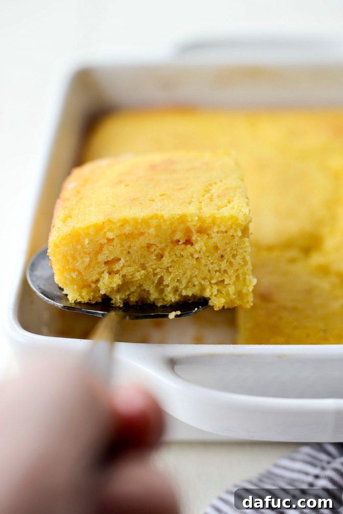 Classic Golden Cornbread 14 A slice of perfectly baked cornbread, showing a tender crumb.