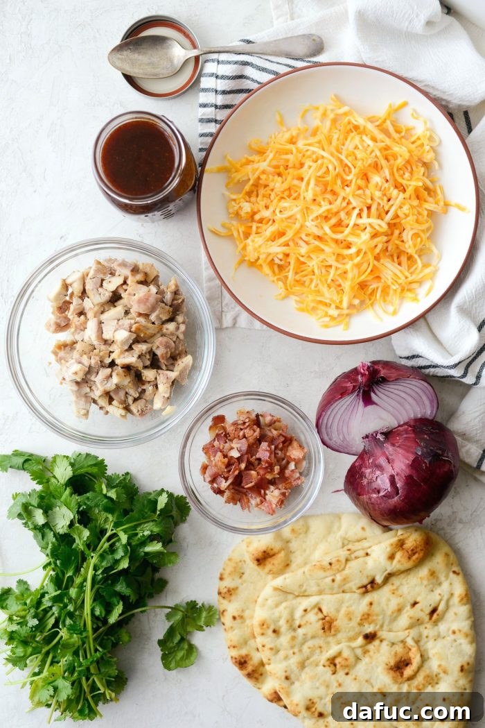 Prepared BBQ Chicken Naan Pizzas on a cutting board, ready to be sliced and served for dinner.