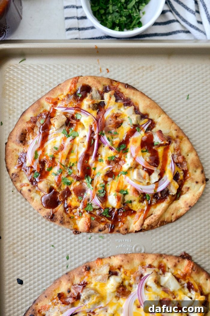 Freshly baked BBQ Chicken Naan Pizza with melted cheese and crispy edges, hot from the oven.