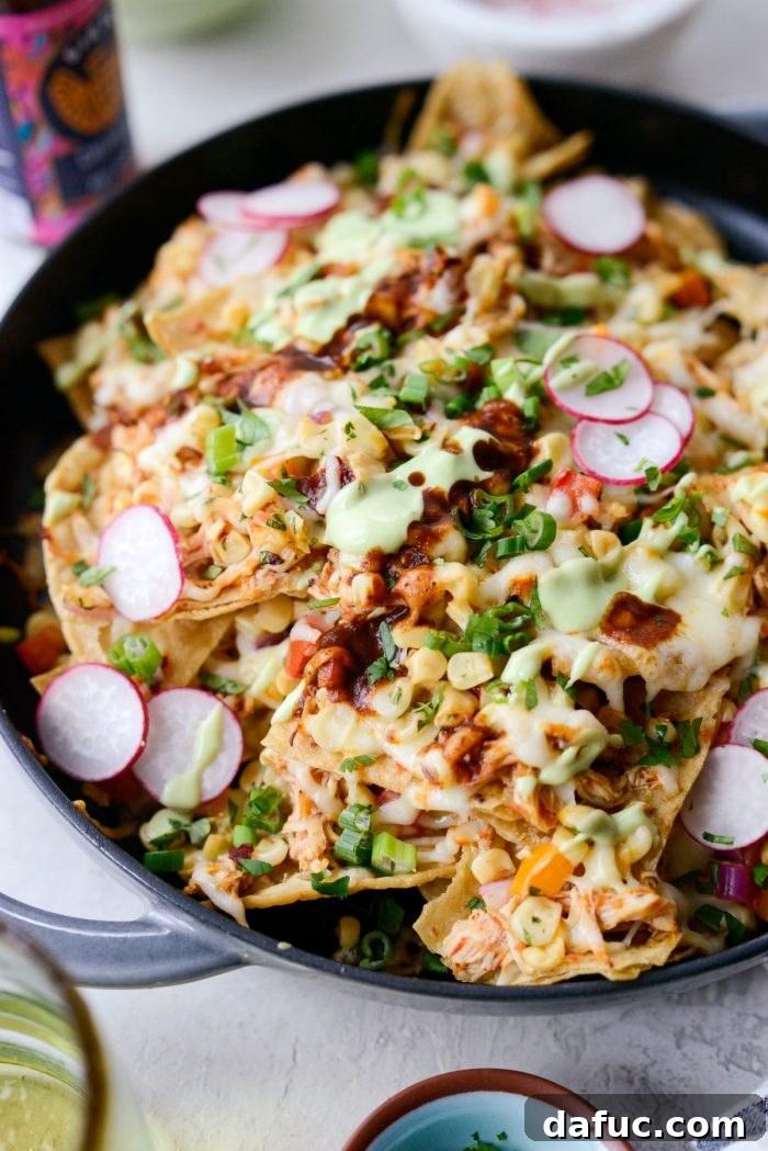 Golden Lava Chicken Nachos 14 Overhead shot of a full platter of Jacuzzi Chicken Nachos, garnished with all toppings, ready for serving and sharing.