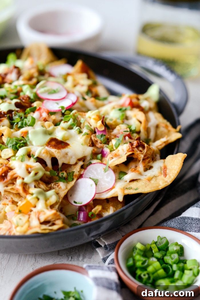 Golden Lava Chicken Nachos 3 Close-up of Jacuzzi Chicken Nachos layers: crispy tortilla chips, generous shredded chicken, smoky corn salsa, and bubbling Muenster cheese. Perfect for sharing.