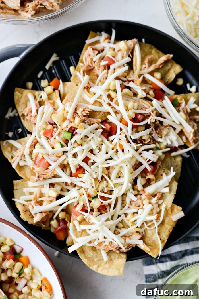 Golden Lava Chicken Nachos 7 Adding smoky chipotle corn salsa as the next layer on the Jacuzzi Chicken Nachos, complementing the chicken and cheese.