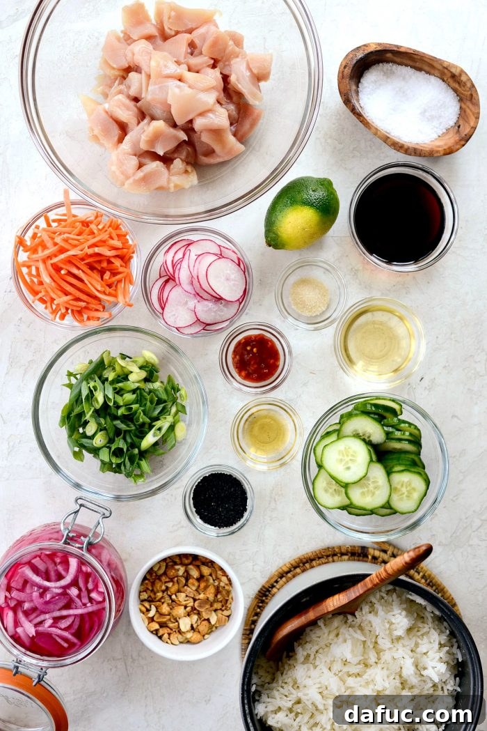 Zesty Ponzu Chicken Rice Bowls 4 Top-down shot of fresh ingredients laid out for ponzu chicken rice bowls, including chicken, vegetables, and sauce components.