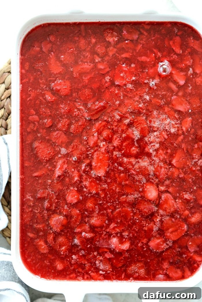 The finished strawberry pretzel dessert bars, perfectly chilled and set, showcasing all three distinct layers.