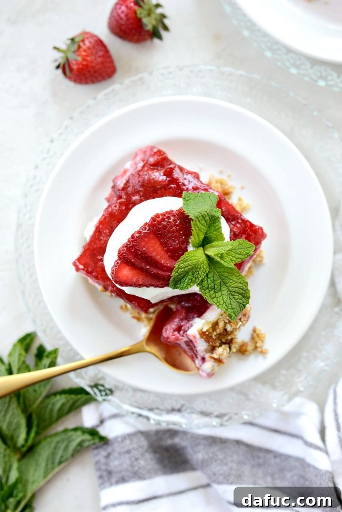 A top-down photo of the completed strawberry pretzel dessert bars, showcasing their vibrant color and neat presentation.