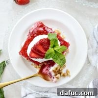 A close-up of a finished Strawberry Pretzel Dessert Bar, showcasing the three layers.