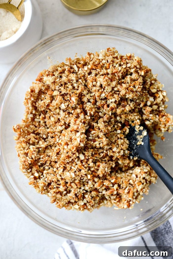 The pretzel and almond mixture, now thoroughly combined with melted butter, ready to be pressed into the baking dish.