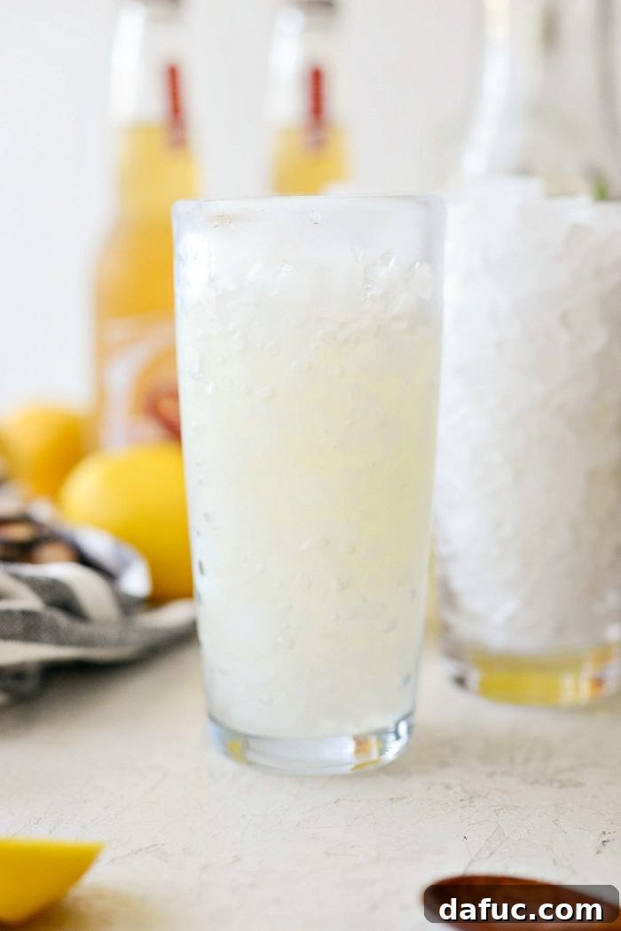 glass filled partly with sweetened lemon gin mixer